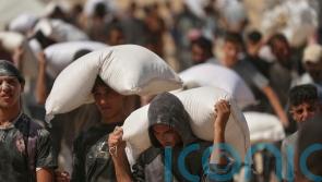 At least 27 people seeking food killed by Israeli gunfire, health officials say