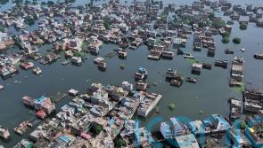 Four killed and dozens trapped under debris as flash floods hit northern India