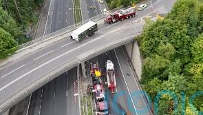Man seriously injured after tractor falls onto motorway from bridge