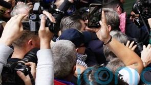 Hundreds greet Kneecap rapper as he arrives at court on terror charge