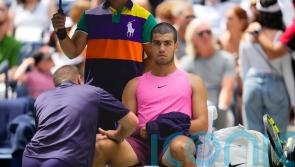 Carlos Alcaraz plays down concerns over knee issue after easing to victory