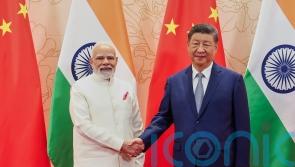 Chinese and Indian leaders meet for talks and vow to resolve border differences