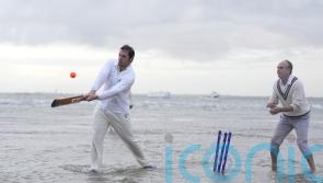In Pictures: Waterlogged pitch perfect for cricketers playing annual game in sea