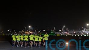 Joggers take off along runway in night-time airport fun run