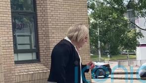 Former MP faces trial accused of possessing false passport