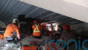 Rescuers search for survivors after school building collapses in Indonesia