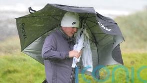 Robert MacIntyre battles brutal conditions to take share of lead on home soil