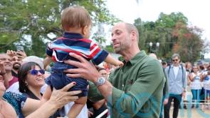 William cuddles baby as he samples island life on trip to Brazilian retreat