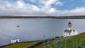 Man spotted clinging to hull of capsized vessel rescued