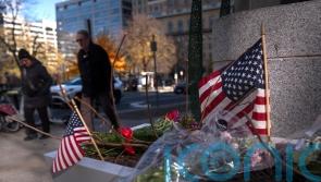 US halts asylum rulings as National Guard shooting suspect faces murder charge