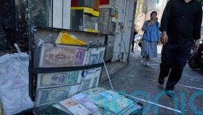 Iran’s currency falls to new low as nuclear sanctions squeeze ailing economy