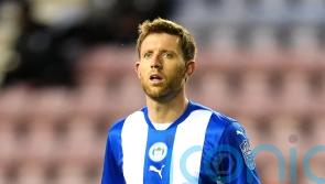 Wigan hold nerve in penalty shootout to see off Barrow