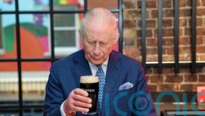 Charles plays barman and pulls the &lsquo;perfect&rsquo; pint of Guinness