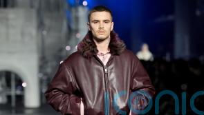 Romeo Beckham and Rosie Huntington-Whiteley on catwalk at London Fashion Week