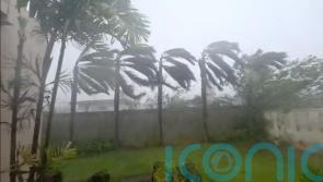 Typhoon blows over cars and rips away roofs on US islands in Pacific