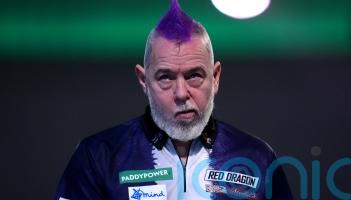 Peter Wright crashes out in round two after predicting he would win title