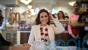 Spice girl: Kate proves partial to a chilli chutney as she meets restaurant team