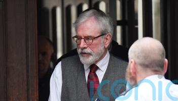Gerry Adams arrives at High Court for bombings trial