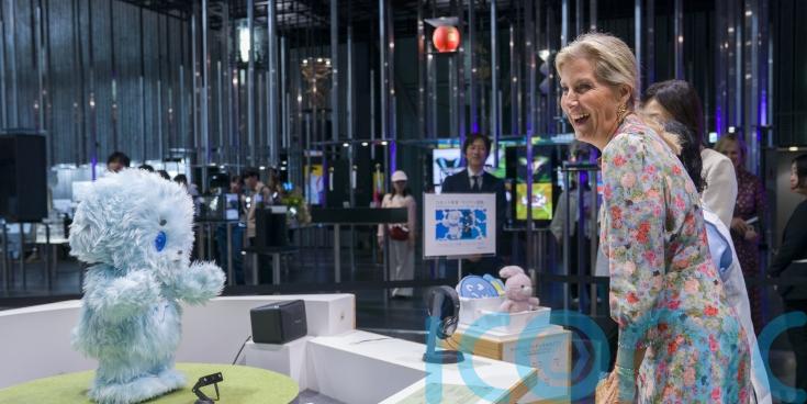 Duchess of Edinburgh interacts with robot dog during Japan visit