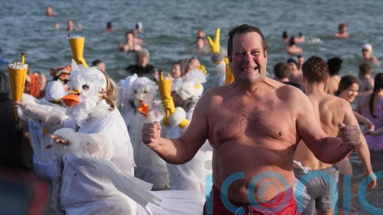 In Pictures: Cold water courage to start the new year as swimmers dive into 2026