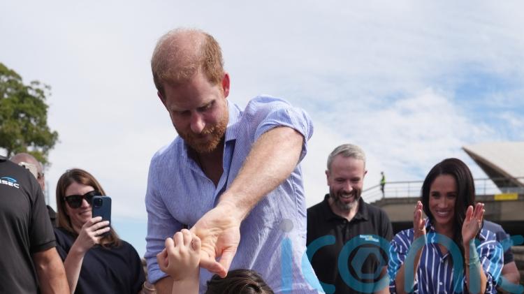 Harry dances with Australian girl before sailing around Sydney Harbour
