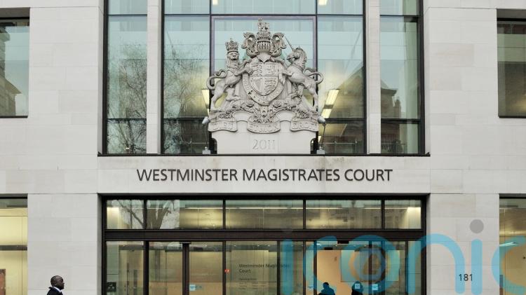 X Factor finalist facing attempted murder charge makes heart sign from dock