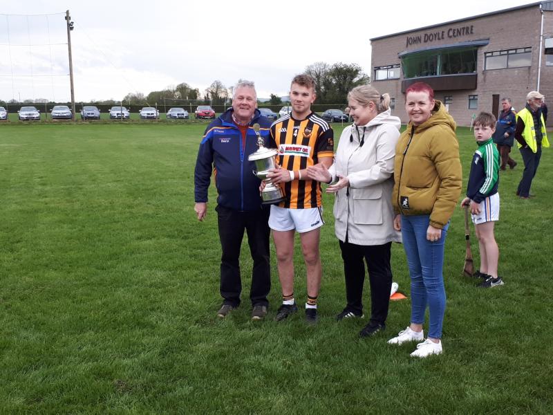 Ger Grants accepts the Cahill Cup for Upperchurch Drombane from Mid Board officers Joe O'Sullivain and Catherine Duune