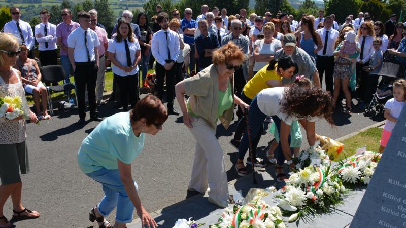 Family making floral tributes at Volunteers' Commemoration 
