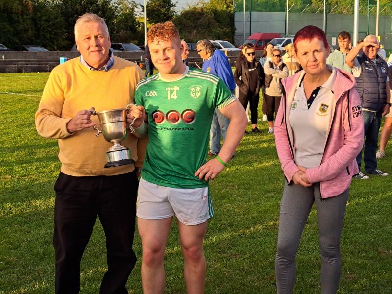 HOlycross Ballycahill captain David Fogarty accepts the silverware from Mid Board Chairman Joe O'Sullivan and Secretary Catherine Dunne.
