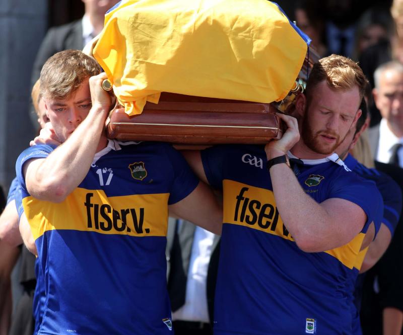 Tipperary players Conor Bowe and Michael Breen carry Dillon Quirke's coffin over the funeral period a month ago. The months mind takes place this Saturday in Clonoulty Rossmore GAA field.