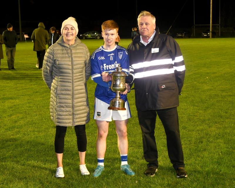 Thurles Sarsfields captain Liam McCormack is presented with the Joe O'Sullivan sponsored Mid U19 A Football trophy after a thrilling encounter with JK Brackens also pictured are Mid Secretary Catherin