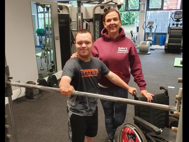 ARMS OF STEEL: Caoimhin Breslin at a gym session with Ruby's Fitness co-founder Bronagh McNamara.