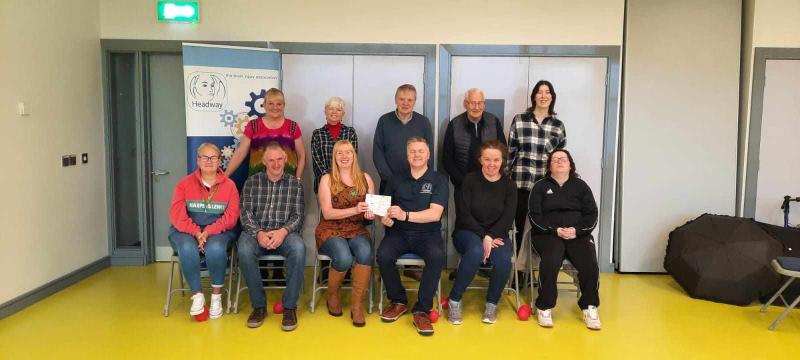 Hilary Duddy presenting her fundraising cheque to the Foyle Headway Team.