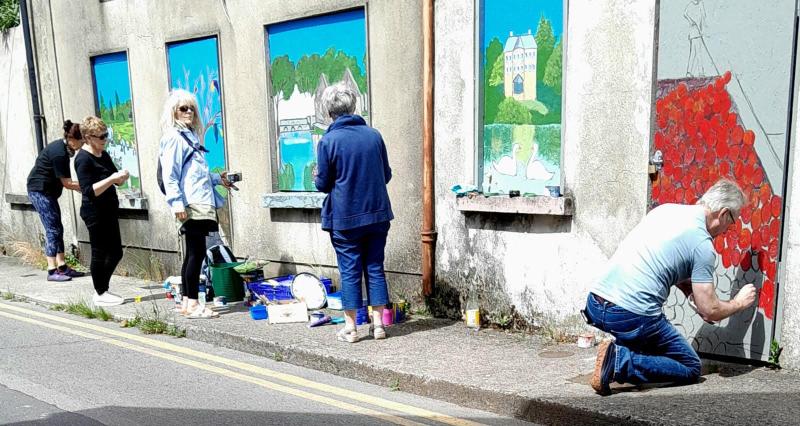 Artists paint boarded-up windows of old buildings in Tipperary 