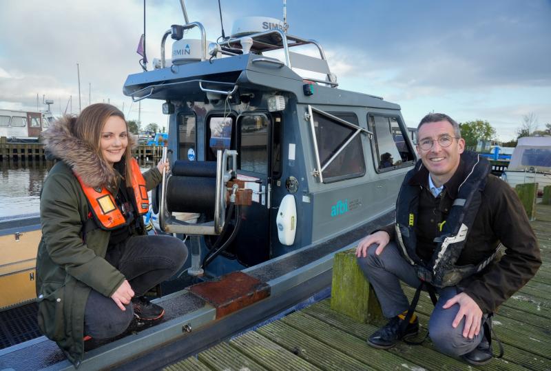 AFBI Freshwater scientist, Faye Shiels with DAERA Minister Andrew Muir