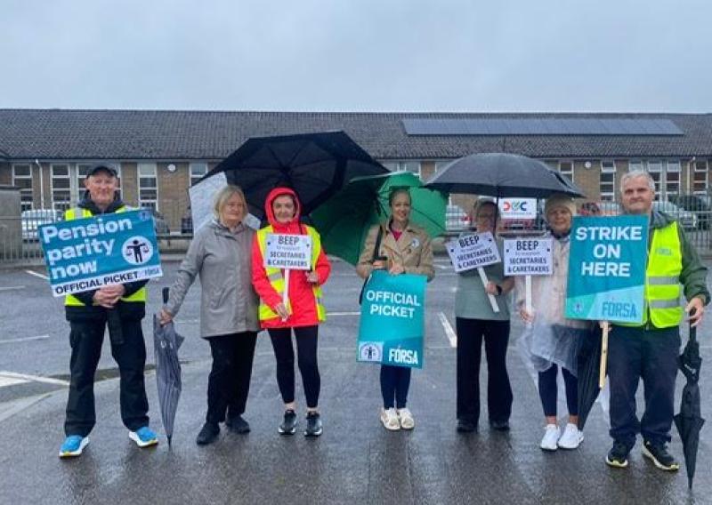 Caretakers Joe Geoghegan, Paddy Scanlon and Secretaries La'Verne Gibbons and Olive Brennan being supported outside Scoil Bhr&iacute;de Clara today