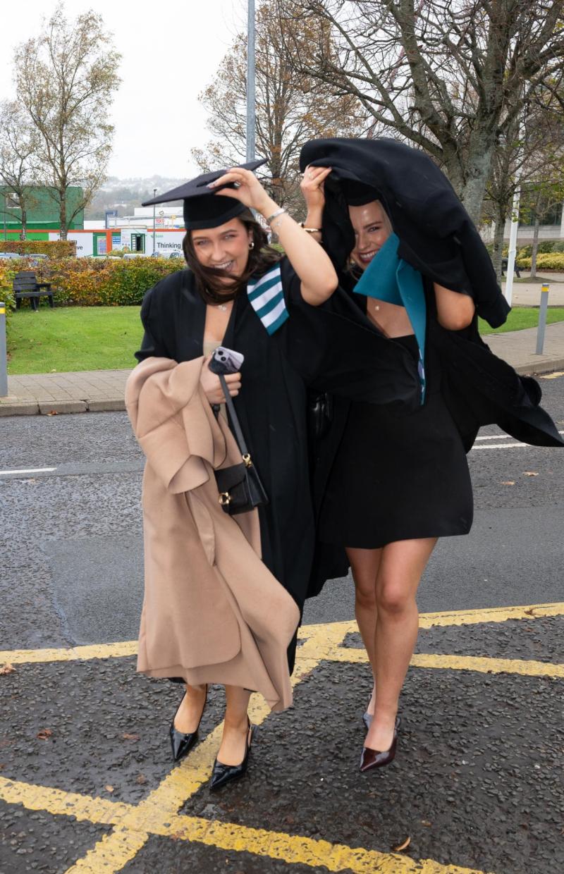 Smiling in the rain! Longford graduate takes shelter from a torrential Donegal downpour