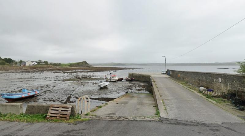 Woman and child receive medical attention as vehicle enters into sea