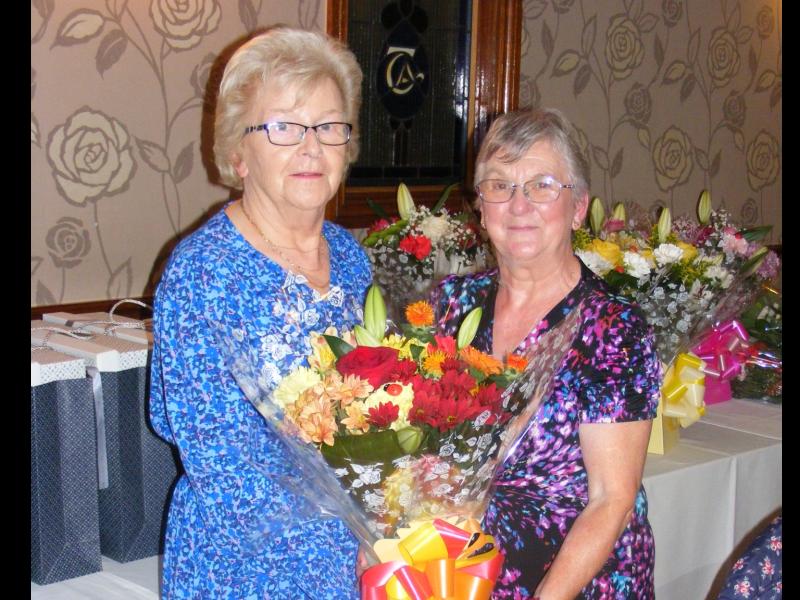 Teresa Devaney making a floral presentation to Maura Sheehan whose late husband Bill was a founder member of Templemore Community Services. 