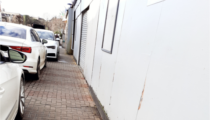 Pedestrians forced onto busy road as cars park on footpath