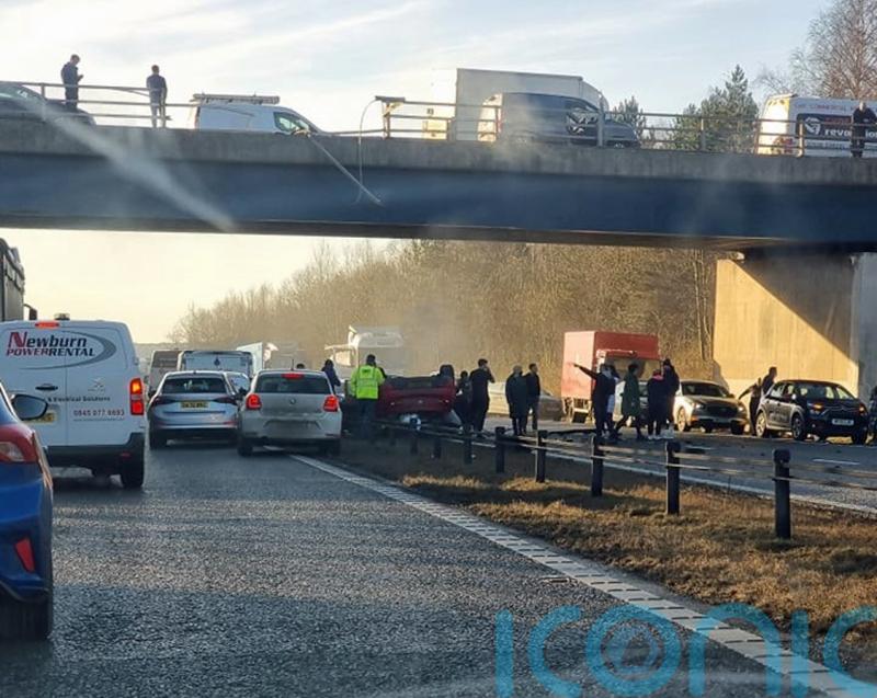 Woman in critical condition after car falls from bridge on to motorway