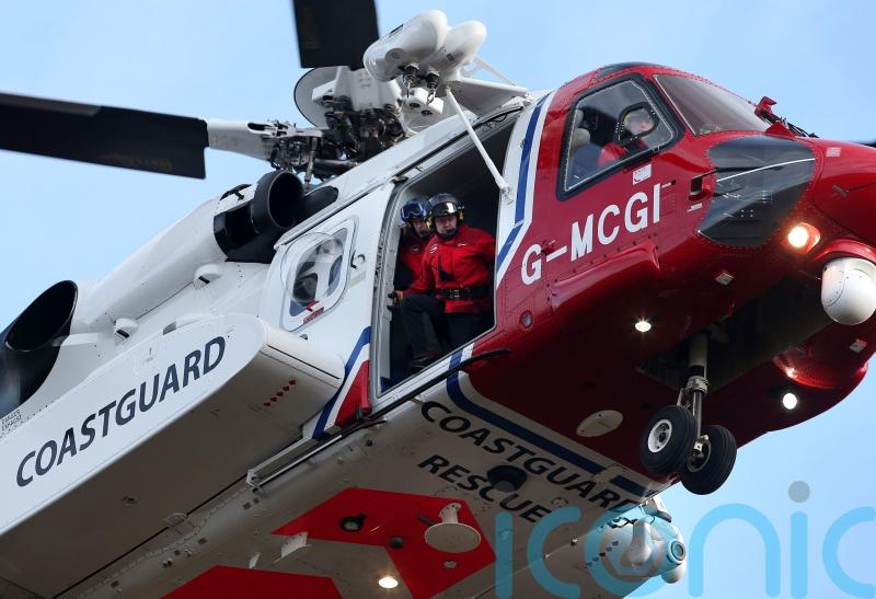 Helicopter and coastguard teams rescue man stuck on steep slope