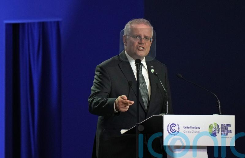 Australia’s prime minister to continue work after testing positive for Covid-19