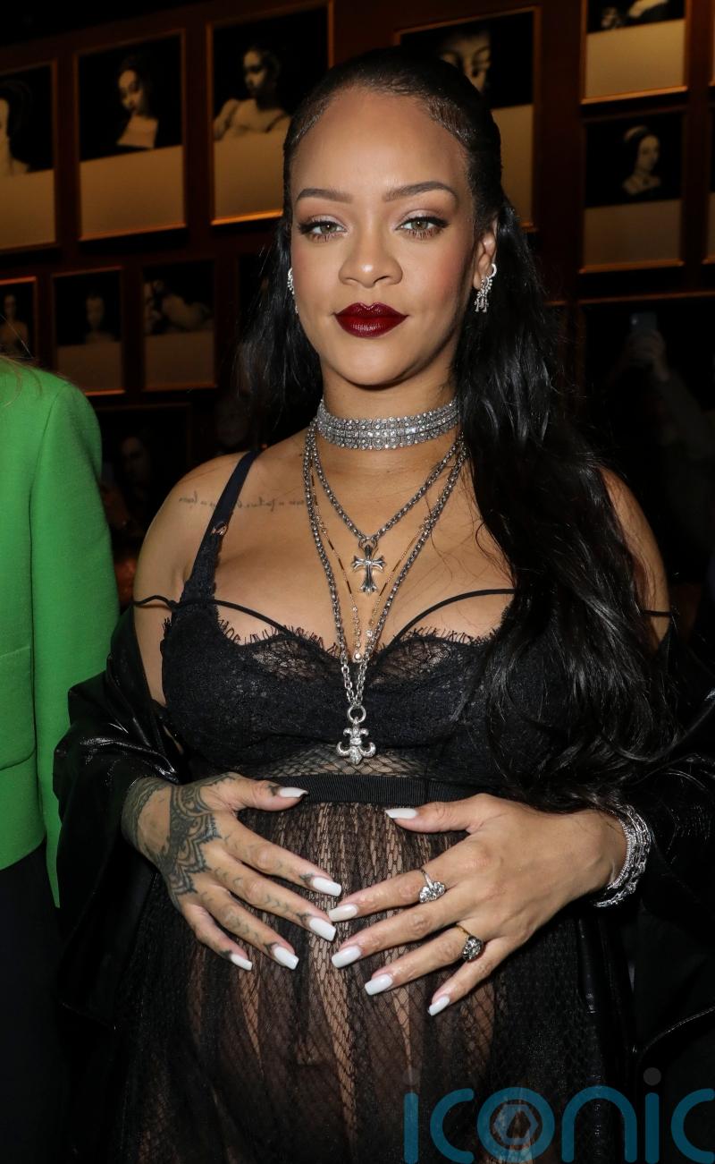 Rihanna shows of baby bump in sheer Dior dress at Paris fashion show
