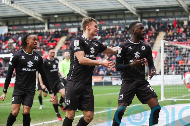 Ten-man MK Dons come from behind to beat leaders Rotherham