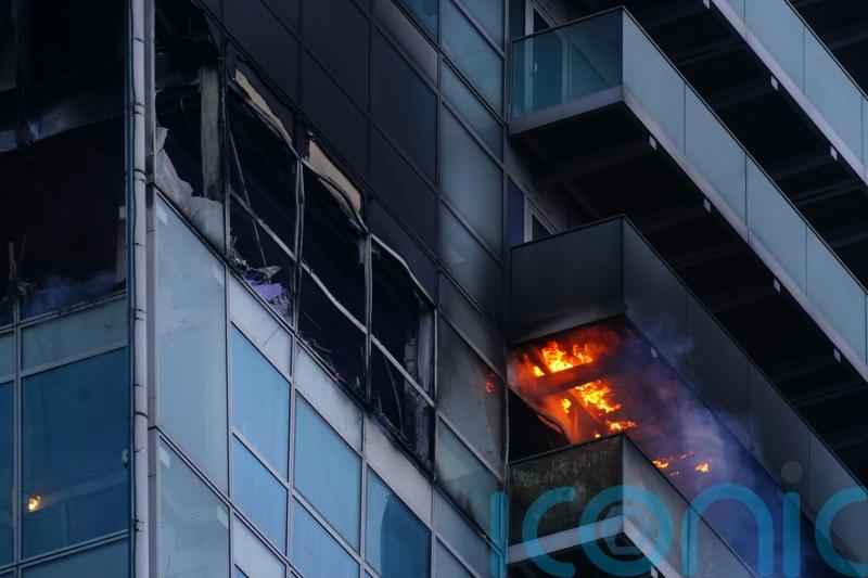 Woman rescued from fire at high-rise block of flats and offices in east London