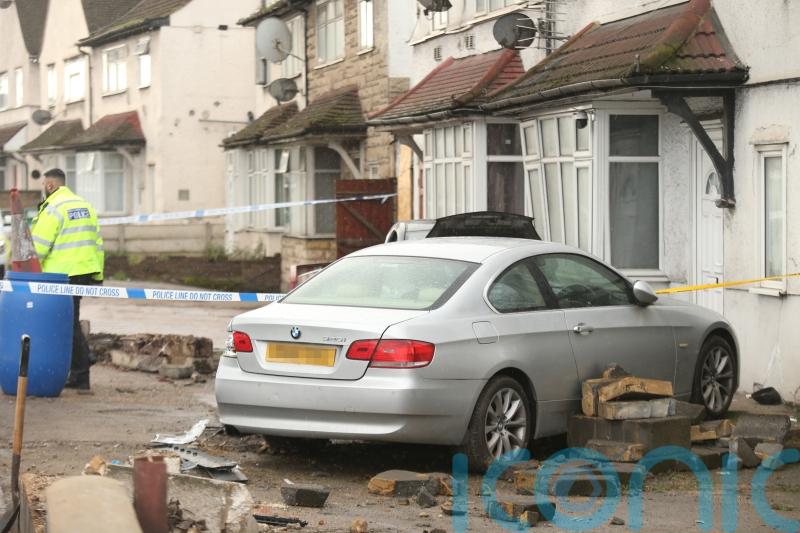 Pedestrian killed as car crashes into house