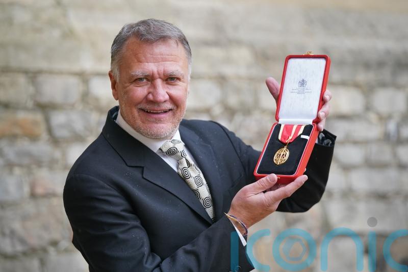 Partner receives knighthood on behalf of late opera director Sir Graham Vick