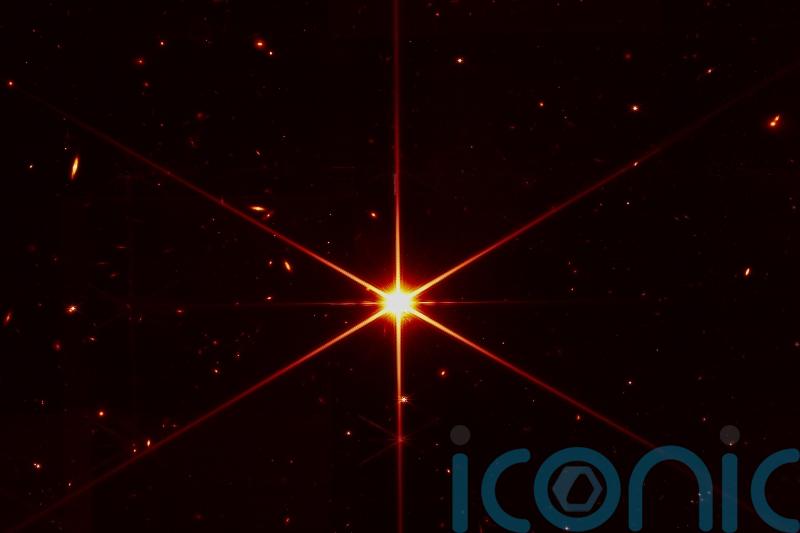 Space telescope’s image of star gets photobombed by galaxies