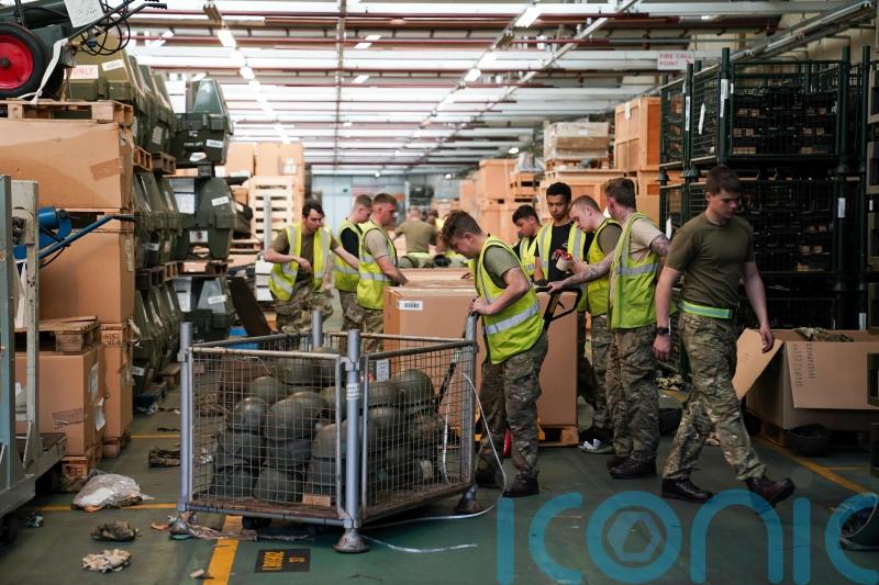 Hats off to Ukraine – UK soldiers pitch in to pack helmets destined for warzone